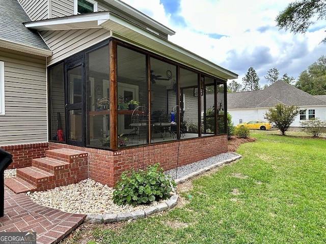 2118 Deer Run Cir, Tifton, GA 31793 - view of property exterior featuring a sunroom, a lawn, and ceiling fan