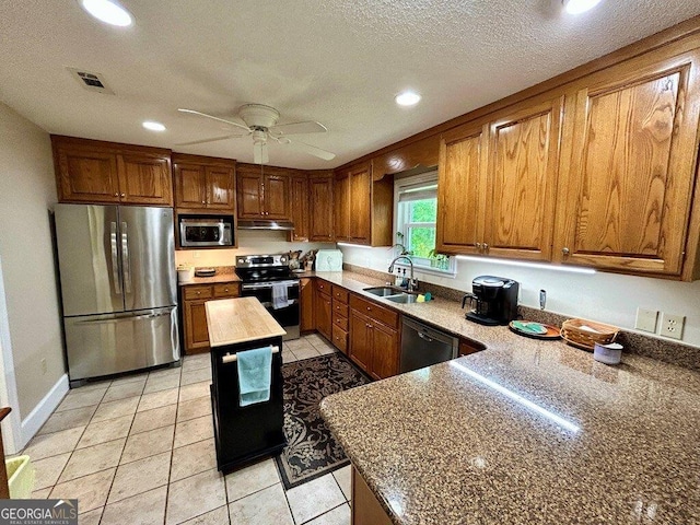 2118 Deer Run Cir, Tifton, GA 31793 - kitchen with stainless steel appliances, a sink, brown cabinetry, recessed lighting, and ceiling fan
