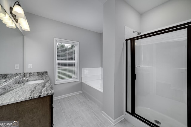 1575 Cabin Creek Trl, Griffin, GA 30223 - bathroom with a shower stall, baseboards, vanity, and a garden tub