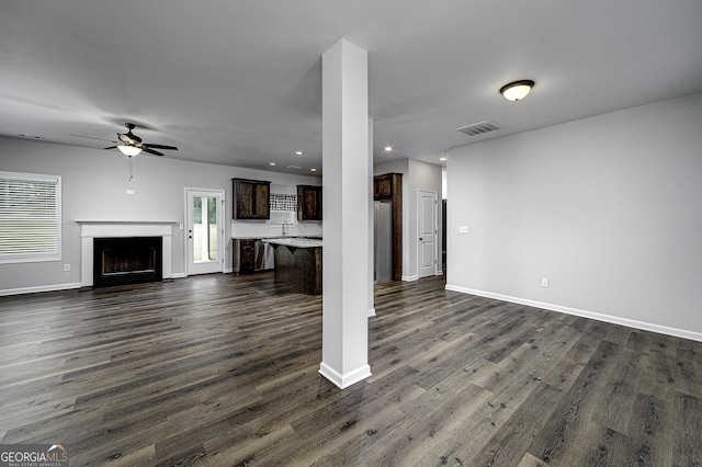 1575 Cabin Creek Trl, Griffin, GA 30223 - unfurnished living room with a ceiling fan, visible vents, a fireplace with flush hearth, and dark wood finished floors