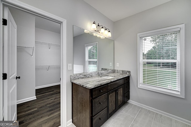1575 Cabin Creek Trl, Griffin, GA 30223 - full bath with a walk in closet, baseboards, a healthy amount of sunlight, and vanity