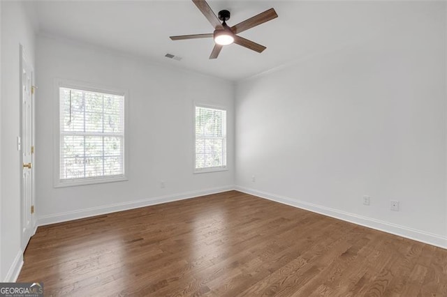 unfurnished room featuring a ceiling fan, visible vents, and wood finished floors