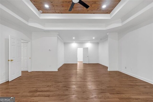 interior space with a ceiling fan, a raised ceiling, wooden ceiling, and ornamental molding