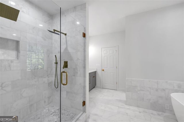 bathroom with a freestanding tub, a marble finish shower, marble finish floor, and vanity