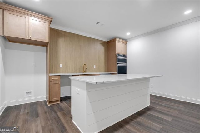 kitchen featuring ornamental molding, dark wood-style flooring, baseboards, stainless steel double oven, and light countertops