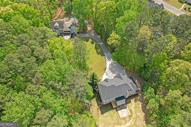 bird's eye view featuring a wooded view