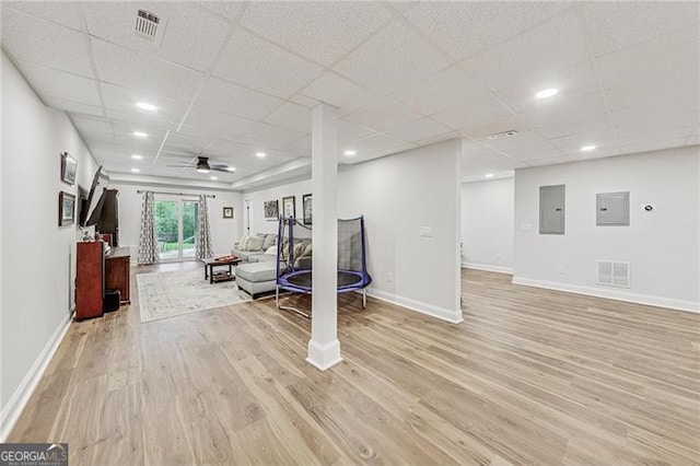 2244 Spink St NW, Atlanta, GA 30318 - living room featuring light wood-style flooring, ceiling fan, a paneled ceiling, electric panel, and recessed lighting