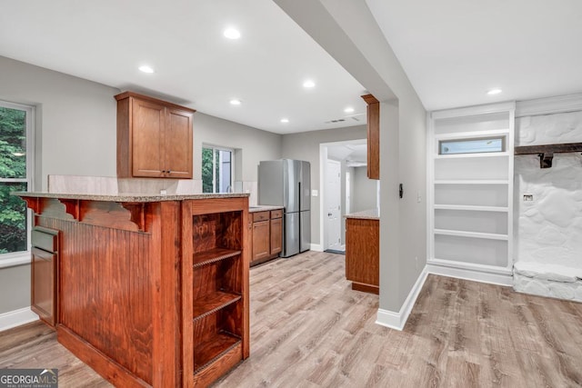 kitchen with recessed lighting, brown cabinets, open shelves, light wood-type flooring, and freestanding refrigerator