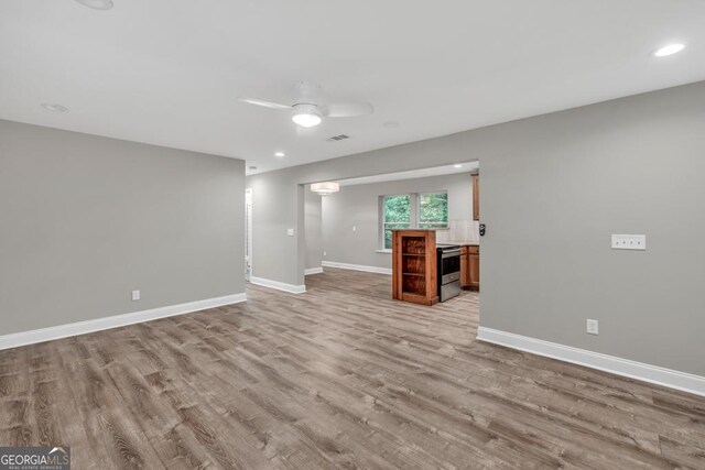 unfurnished living room with light wood-style floors, ceiling fan, visible vents, baseboards, and recessed lighting