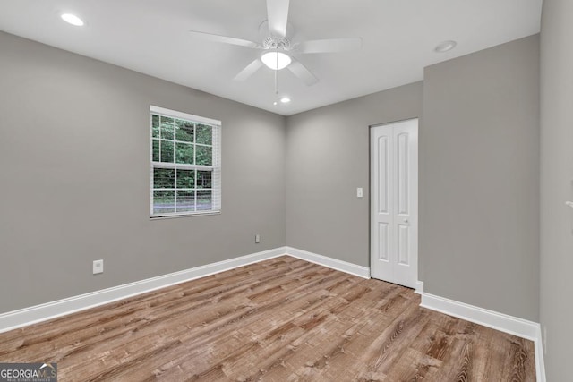 unfurnished room featuring recessed lighting, a ceiling fan, wood finished floors, and baseboards