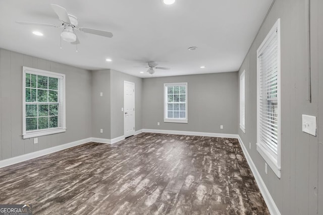 empty room with baseboards, recessed lighting, wood finished floors, and a ceiling fan