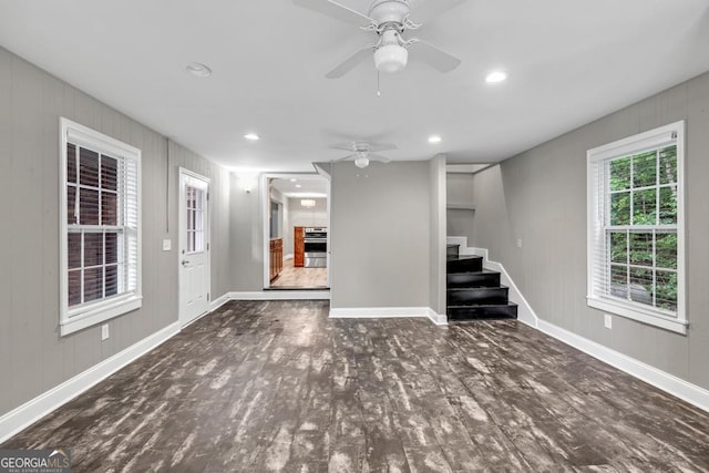 below grade area featuring recessed lighting, stairway, ceiling fan, baseboards, and wood finished floors