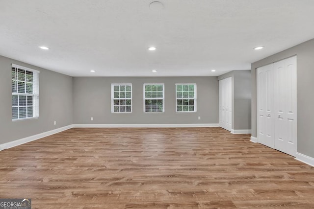 interior space featuring wood finished floors, recessed lighting, and baseboards