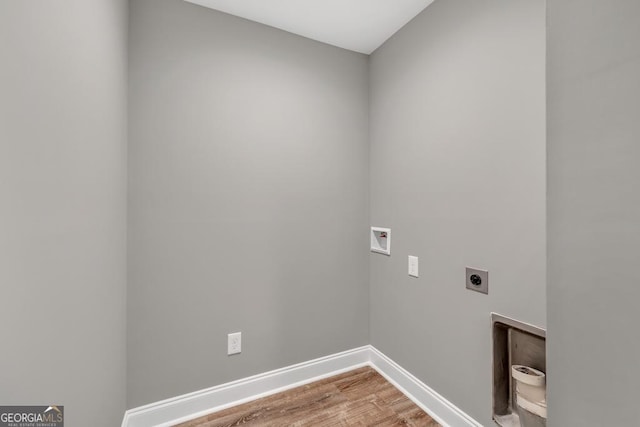 clothes washing area with light wood-style floors, laundry area, electric dryer hookup, hookup for a washing machine, and baseboards