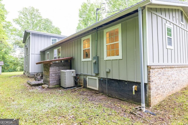 view of side of home with board and batten siding and central AC unit