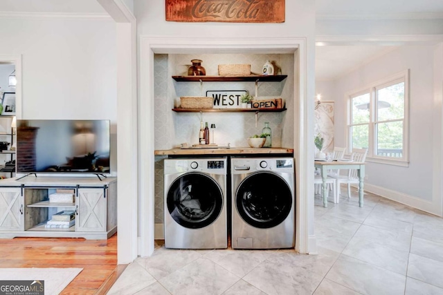 1426 Memorial Dr SE, Atlanta, GA 30317 - clothes washing area with baseboards, crown molding, washer and clothes dryer, and laundry area