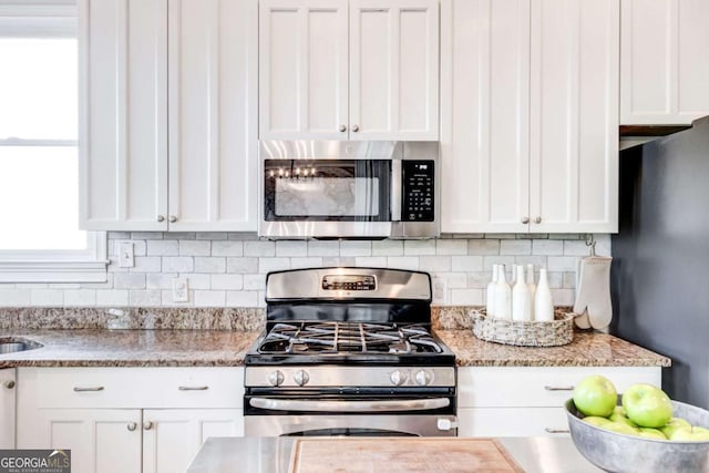 1426 Memorial Dr SE, Atlanta, GA 30317 - kitchen featuring white cabinets, appliances with stainless steel finishes, and tasteful backsplash