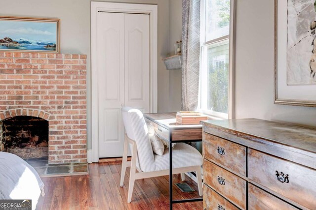 1426 Memorial Dr SE, Atlanta, GA 30317 - dining room featuring wood finished floors, a fireplace, and a healthy amount of sunlight