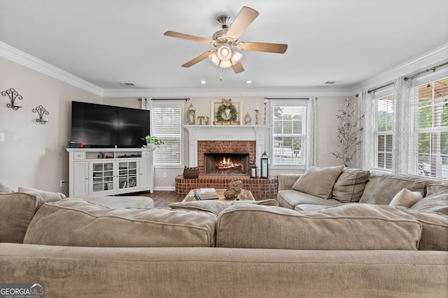 living room featuring ceiling fan, crown molding, wood finished floors, and a fireplace