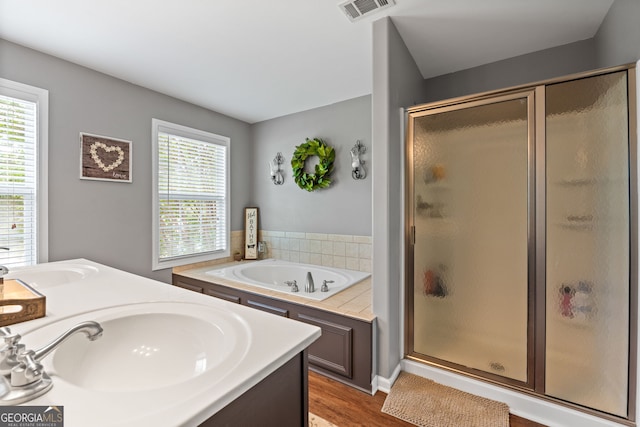 full bath with visible vents, a stall shower, and a sink