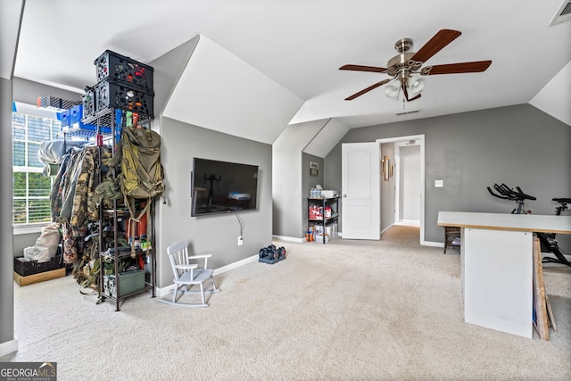 interior space with vaulted ceiling, visible vents, baseboards, and ceiling fan