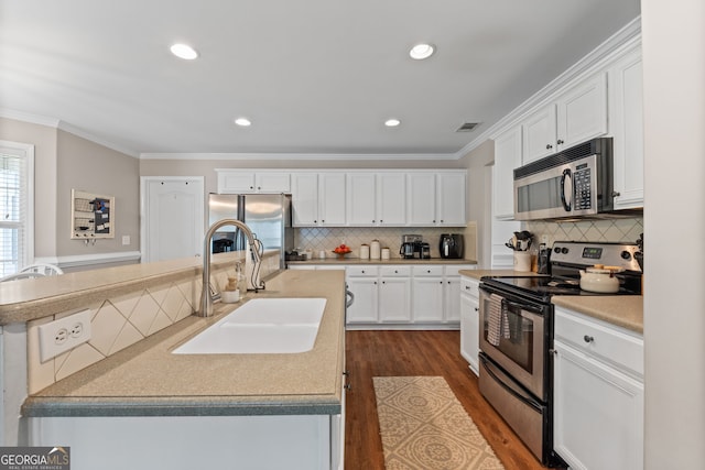 kitchen featuring ornamental molding, visible vents, a sink, and appliances with stainless steel finishes