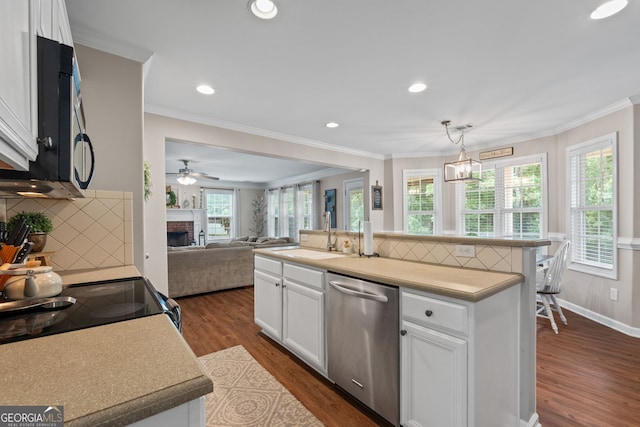 kitchen featuring white cabinets, stainless steel dishwasher, a sink, dark wood-style flooring, and a fireplace