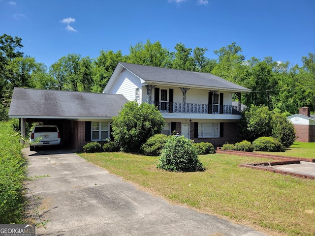 206 New Dr, Claxton, GA 30417 - view of front facade featuring an attached carport, driveway, brick siding, and a front yard