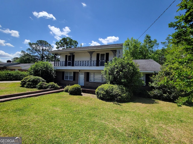 206 New Dr, Claxton, GA 30417 - view of front of home featuring brick siding, a front lawn, and a balcony