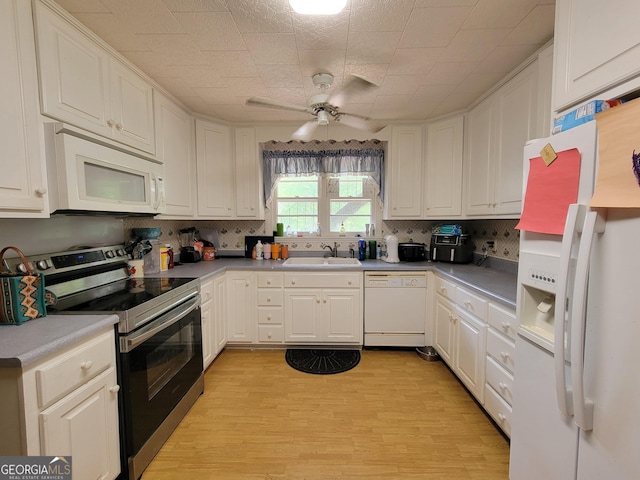 206 New Dr, Claxton, GA 30417 - kitchen with white appliances, white cabinetry, a ceiling fan, and tasteful backsplash