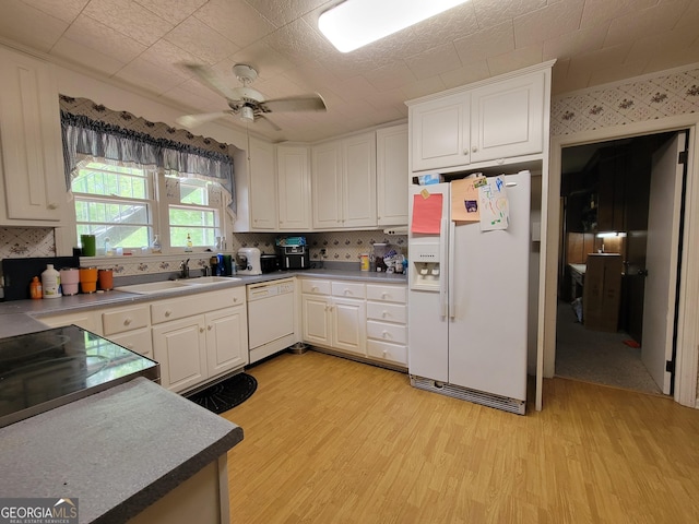 206 New Dr, Claxton, GA 30417 - kitchen featuring tasteful backsplash, a sink, white cabinets, light wood finished floors, and white appliances