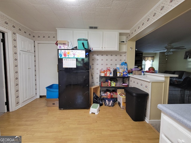 206 New Dr, Claxton, GA 30417 - kitchen featuring open shelves, light wood finished floors, freestanding refrigerator, and wallpapered walls