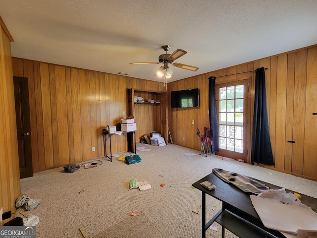 206 New Dr, Claxton, GA 30417 - interior space with visible vents, wood walls, a textured ceiling, and ceiling fan