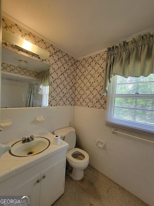 206 New Dr, Claxton, GA 30417 - bathroom with tile walls, wallpapered walls, vanity, and toilet