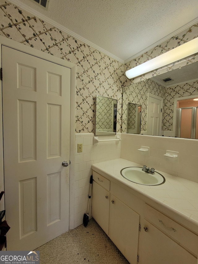 206 New Dr, Claxton, GA 30417 - bathroom with a textured ceiling, vanity, a wainscoted wall, ornamental molding, and wallpapered walls