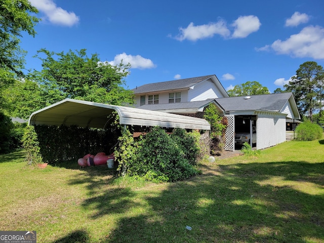 206 New Dr, Claxton, GA 30417 - rear view of house featuring a yard and a carport