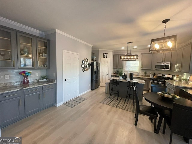 dining room with ornamental molding, light wood-style floors, baseboards, recessed lighting, and a chandelier