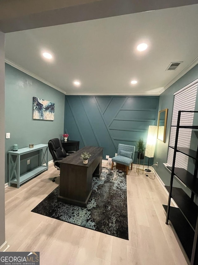 office featuring visible vents, ornamental molding, and wood finished floors