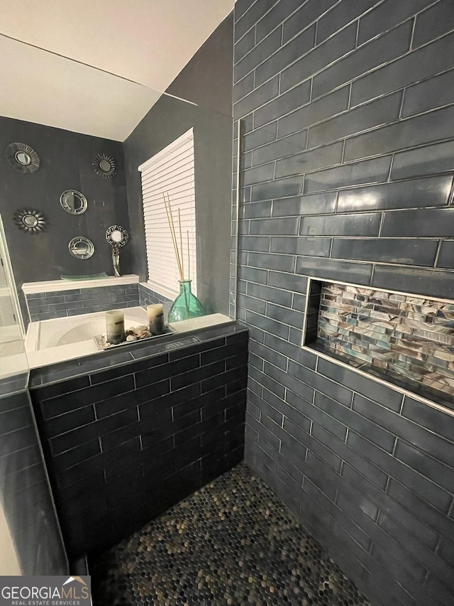 full bathroom with tiled shower