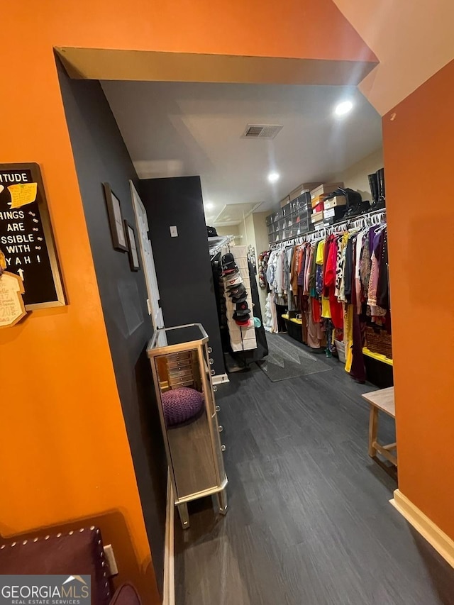 spacious closet featuring visible vents and dark wood-style floors