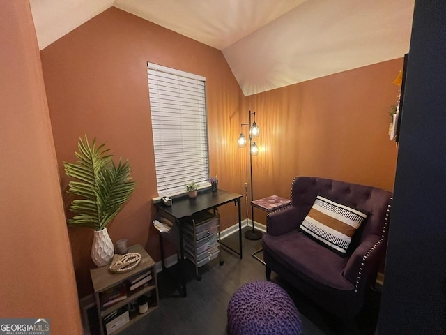 sitting room with wood finished floors and vaulted ceiling