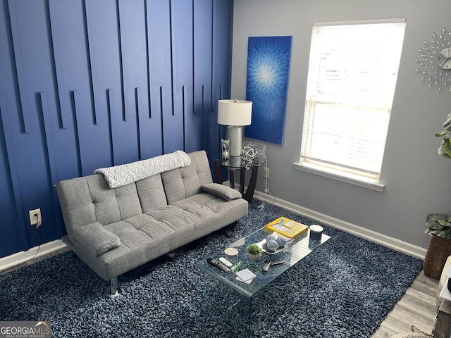 living area featuring baseboards and wood finished floors
