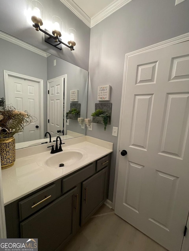 bathroom with crown molding and vanity