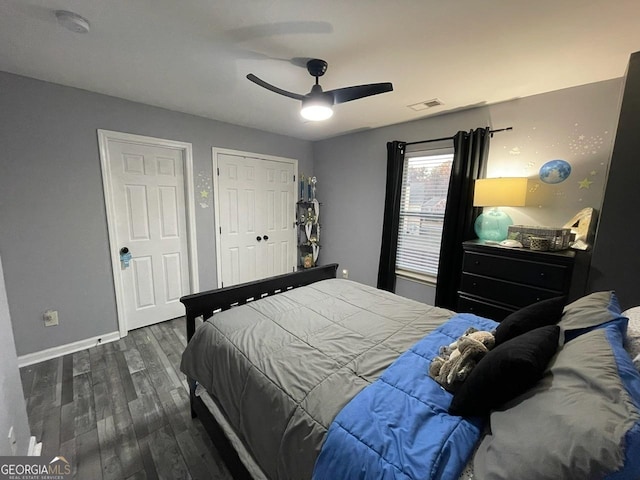 bedroom with ceiling fan, baseboards, visible vents, and wood finished floors