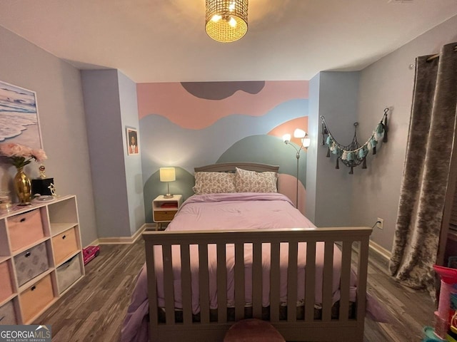 bedroom featuring baseboards and wood finished floors