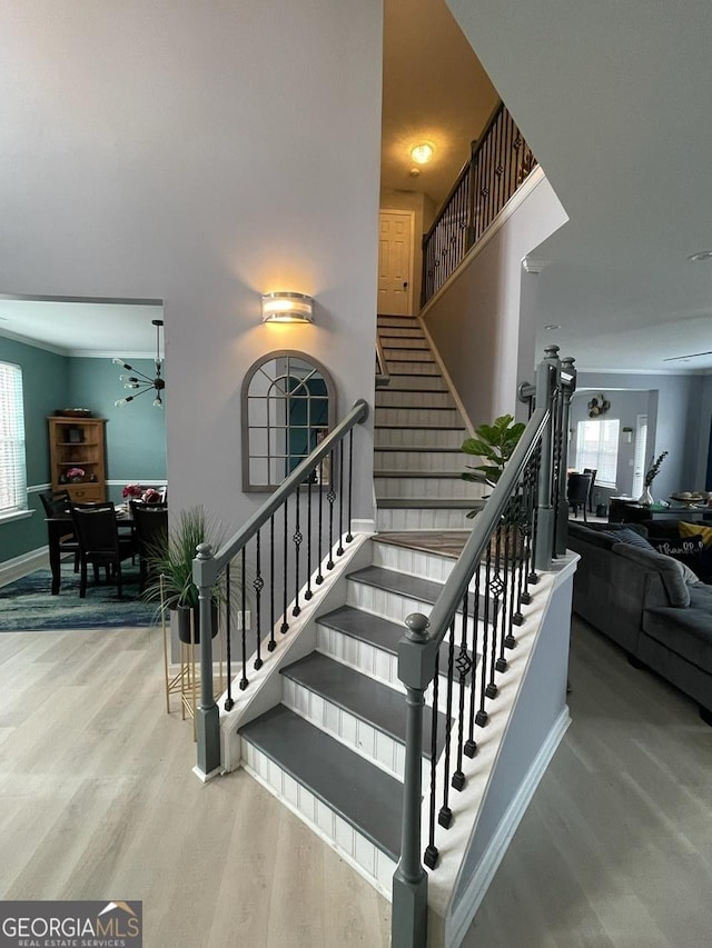 stairway with baseboards and wood finished floors