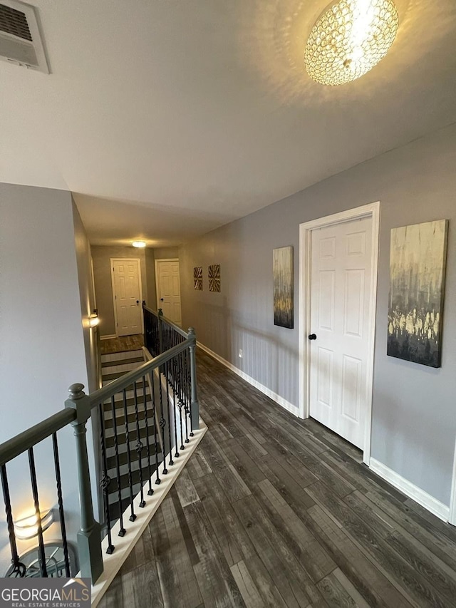 interior space with visible vents, baseboards, and wood finished floors