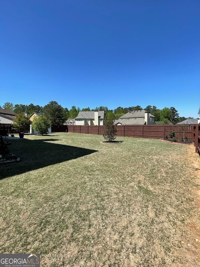 view of yard with a fenced backyard
