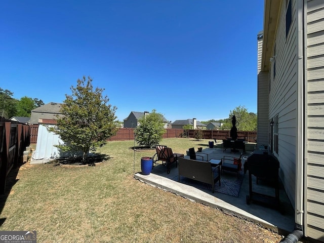 view of yard featuring a fenced backyard, a patio area, and an outdoor hangout area