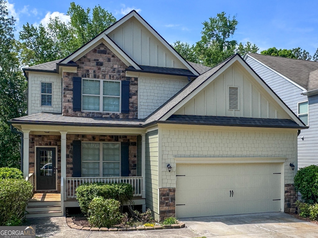 251 Shaw Dr, Acworth, GA 30102 - craftsman-style house featuring board and batten siding, stone siding, a porch, a shingled roof, and a garage